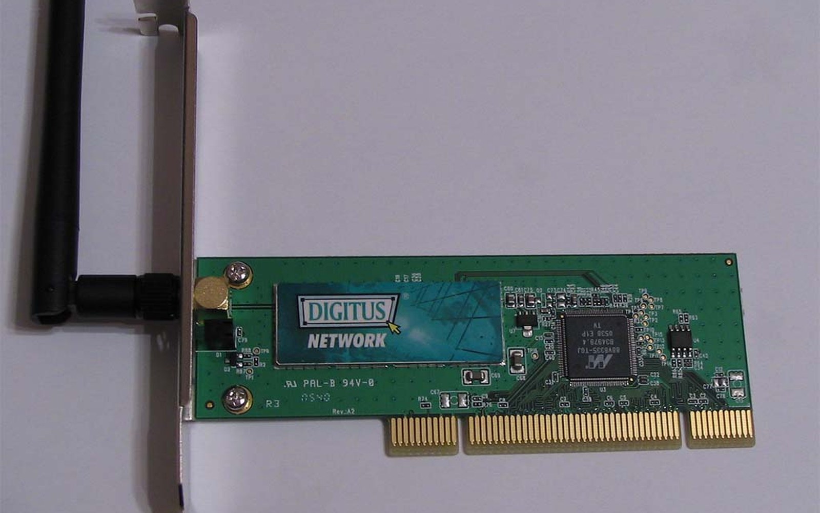 A green Digitus PCI wireless network card with an attached black antenna